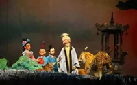 孝义木偶戏主要流行于哪些地方？表现手法有什么特色？